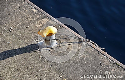 Dock at the lock for the addition of river cargo ships. metal bollards for mooring steel ropes on the navigation channel. waterfro Stock Photo