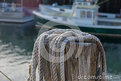 Dock side hemp hawser rope ready to be used to moor lobster boat Stock Photo