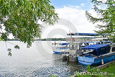 Docked boats on Herastrau Park Lake are waiting the tourists for sail Stock Photo