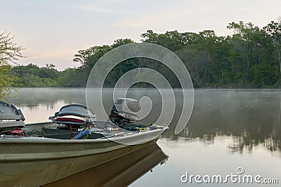 Docked river fishing boat and crisp sunrise mist Stock Photo