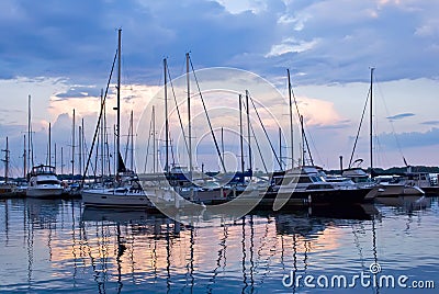 Docked sailboats at sunset Stock Photo