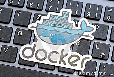 Docker logo placed over a laptop computer keyboard, Docker engine containers virtualization technology used in software Editorial Stock Photo