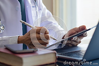 Doctor using digital tablet, work on laptop computer Stock Photo