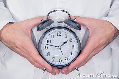 Doctor with alarm clock Stock Photo