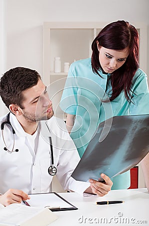 Doctor analysing results of X-ray Stock Photo