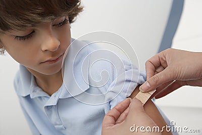 Doctor Applying Bandage On Patient's Arm Stock Photo