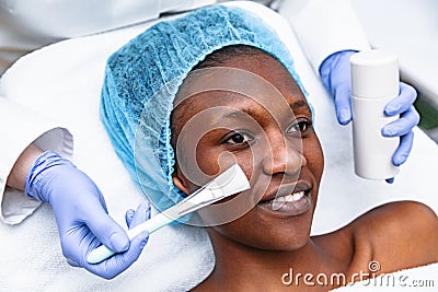 Doctor is applying with brush mask on woman in spa salon Stock Photo