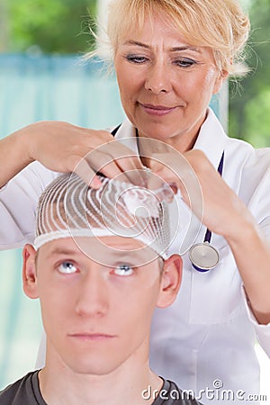 Doctor applying dressing after head injury Stock Photo