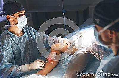 Doctor and an assistant in operating room for surgical clinic Stock Photo