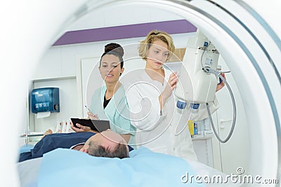 Doctor assistant and patient in mri room at hospital Stock Photo