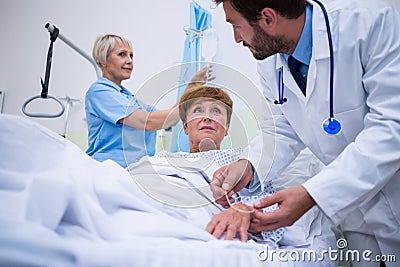 Doctor attaching iv drip on patient s hand Stock Photo