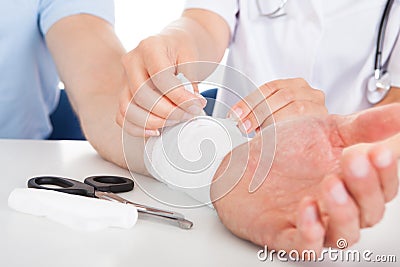 Doctor bandaging patient Stock Photo