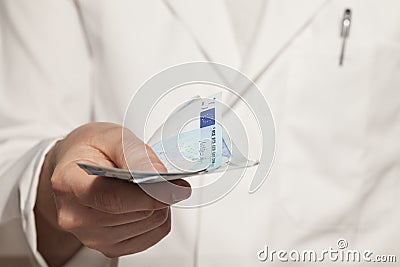 Doctor with banknotes Stock Photo