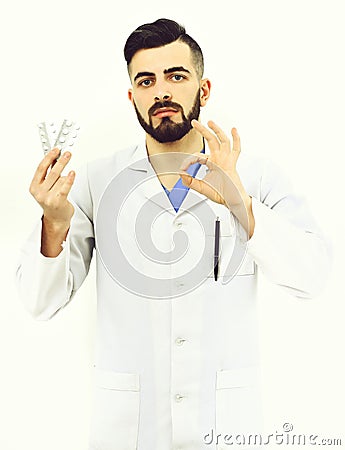 Doctor with beard holds pills blisters and shows ok sign Stock Photo