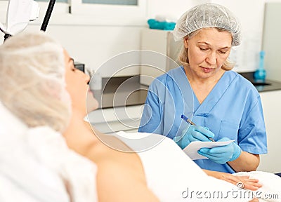 Doctor beautician polls a patient at the clinic Stock Photo