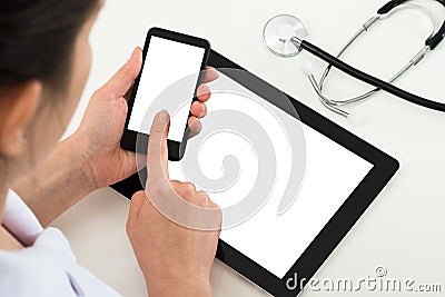 Doctor with blank display mobile phone and digital tablet Stock Photo