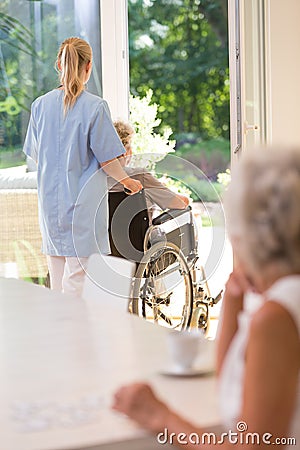 Doctor helping elder lady Stock Photo