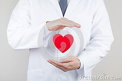 Doctor cardiologist hands with flying heart. Cardiology and heart disease concept. Stock Photo