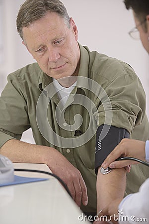 Doctor checking blood pressure Stock Photo