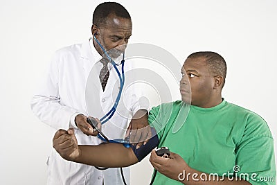 Doctor Checking Blood Pressure Of An Obese Patient Stock Photo