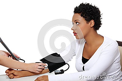 Doctor checking blood pressure of pregnant woman. Stock Photo