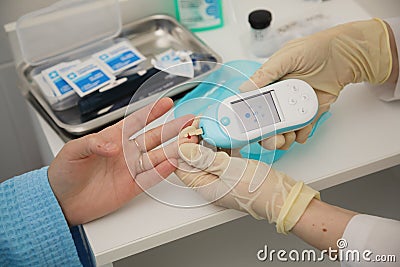 Doctor checking blood sugar level. doctor patient diabetes lancet glucometer blood glucose office concept Stock Photo