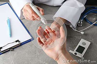 Doctor checking blood sugar level in patient diabetes on table Stock Photo