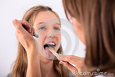 Doctor Checking Girl`s Sore Throat Stock Photo