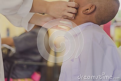 Doctor is checking the oral cavity of a student Stock Photo