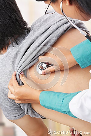 Doctor checking patient heart beat Stock Photo
