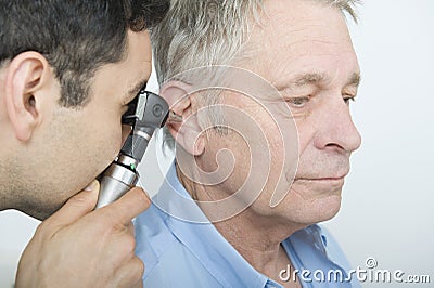 Doctor Checking Patient's Ear Using Otoscope Stock Photo