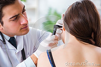 The doctor checking patients ear during medical examination Stock Photo