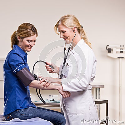 Doctor checking woman blood pressure Stock Photo