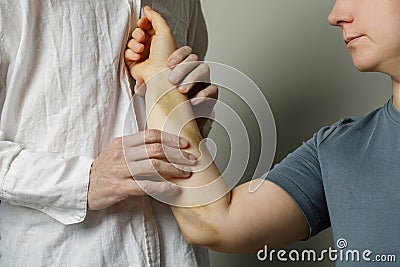 Doctor checking woman patient with bruise in hospital Stock Photo