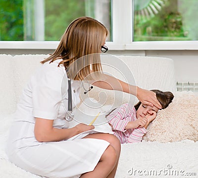 Doctor checks the temperature of a girl touching his forehead Stock Photo