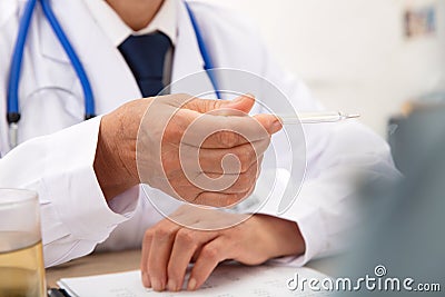 The doctor checks the thermometer Stock Photo