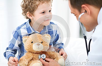 Doctor and child patient. Physician examines little boy by stethoscope. Medicine and children`s therapy concept Stock Photo