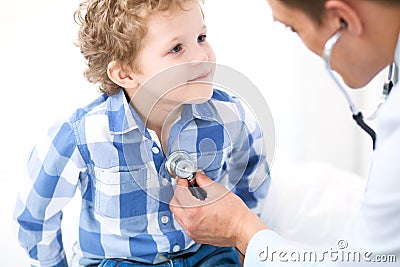 Doctor and child patient. Physician examines little boy by stethoscope. Medicine and children`s therapy concept Stock Photo