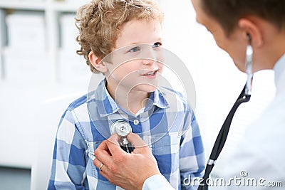 Doctor and child patient. Physician examines little boy by stethoscope. Medicine and children`s therapy concept Stock Photo
