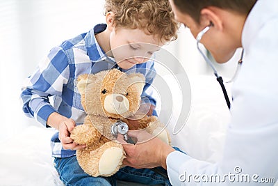 Doctor and child patient. Physician examines little boy by stethoscope. Medicine and children`s therapy concept Stock Photo