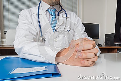 Doctor with clasped hands is listening. Expertise consultation concept Stock Photo