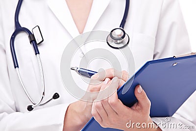 Doctor completing on medical card. Stock Photo
