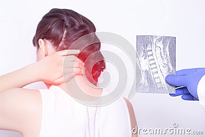 The doctor conducts a medical examination. She holds an X-ray examination of a girl who has pain in the neck, pinching the nerve Stock Photo