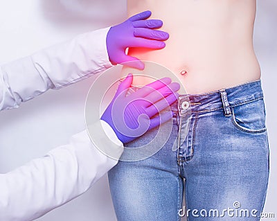 The doctor conducts a visual inspection and palpation of the patient s abdomen on suspicion of acute apendicitis and inflammation Stock Photo