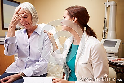 Doctor In Consultation With Senior Concerned Female Patient Stock Photo