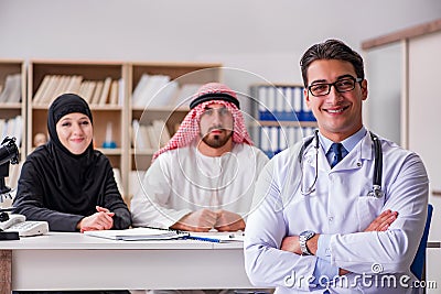 The doctor consulting arab family at hospital Stock Photo