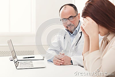 Doctor consulting woman in hospital Stock Photo