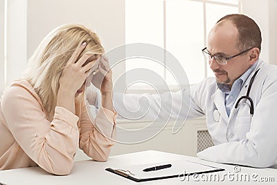Doctor consulting woman in hospital Stock Photo