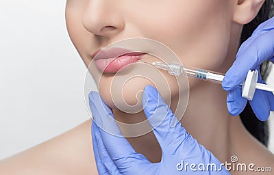 The doctor cosmetologist makes Lip augmentation procedure of a beautiful woman in a beauty salon Stock Photo