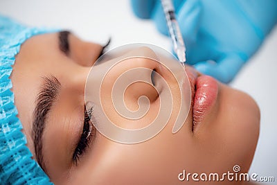 The doctor cosmetologist makes the Rejuvenating facial injections procedure for tightening and smoothing wrinkles on the Stock Photo